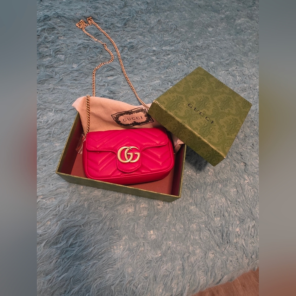 Gucci GG Marmont matelassé super mini bag in red quilted leather.